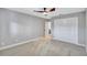 Neutral bedroom features carpet, ceiling fan and door leading to bathroom at 3923 Hudson Ln, Tampa, FL 33618