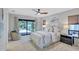 Bright bedroom featuring a ceiling fan, neutral walls and décor, and sliding doors to the pool area at 3923 Hudson Ln, Tampa, FL 33618