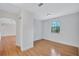 This is a bright bedroom with a large window and wood-look laminate flooring throughout at 3923 Hudson Ln, Tampa, FL 33618