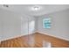 A bright bedroom with a window for natural light, featuring wood-look laminate flooring throughout at 3923 Hudson Ln, Tampa, FL 33618
