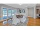 Open dining room with white linen chairs, French doors to the pool and bright lighting at 3923 Hudson Ln, Tampa, FL 33618