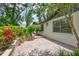 Charming single-story home with lush landscaping and a brick-paved patio at 3923 Hudson Ln, Tampa, FL 33618