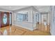 Open-concept home with light-filled foyer and hardwood floors with view to living area at 3923 Hudson Ln, Tampa, FL 33618