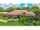 Charming brick home with well-manicured lawn, trimmed shrubs, and beautiful landscaping at 3923 Hudson Ln, Tampa, FL 33618