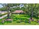 A beautiful brick home with a large landscaped front lawn and mature shade trees at 3923 Hudson Ln, Tampa, FL 33618