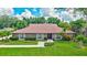 Charming brick home with well-manicured lawn, trimmed shrubs, and beautiful landscaping at 3923 Hudson Ln, Tampa, FL 33618