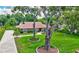 This is an aerial view of a home's front yard with a long driveway and beautiful, mature landscaping at 3923 Hudson Ln, Tampa, FL 33618
