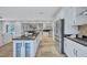 Bright kitchen with white cabinets and countertops and stainless steel appliances overlooking the outdoor pool at 3923 Hudson Ln, Tampa, FL 33618
