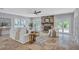 Comfortable living room with stone fireplace, neutral color scheme, tile floors, and bright lighting at 3923 Hudson Ln, Tampa, FL 33618