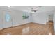 Bright and airy living room with hardwood floors, ceiling fan, and abundant natural light at 3923 Hudson Ln, Tampa, FL 33618