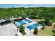 Aerial view of blue pickle ball courts and green landscaping at 4147 Grandchamp Cir, Palm Harbor, FL 34685