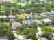Aerial view of a two-story home nestled in a neighborhood with mature trees at 4147 Grandchamp Cir, Palm Harbor, FL 34685