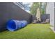 Artificial turf backyard with sunshade, lounge chairs, and dog run at 4147 Grandchamp Cir, Palm Harbor, FL 34685
