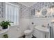 Charming powder room with blue patterned wallpaper, bead-board, and a pedestal sink at 4147 Grandchamp Cir, Palm Harbor, FL 34685
