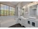 Bright bathroom with double vanity, soaking tub and natural light at 4147 Grandchamp Cir, Palm Harbor, FL 34685