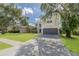 Two-story home featuring an arched entryway, well-kept lawn, and a two-car garage at 4147 Grandchamp Cir, Palm Harbor, FL 34685