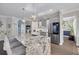 Modern kitchen featuring stainless steel appliances and a granite island with seating at 4147 Grandchamp Cir, Palm Harbor, FL 34685