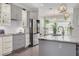Bright kitchen featuring gray and white cabinetry, granite countertops, and stainless steel appliances at 4147 Grandchamp Cir, Palm Harbor, FL 34685
