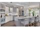Modern kitchen featuring stainless steel appliances, a granite island, and pendant lighting at 4147 Grandchamp Cir, Palm Harbor, FL 34685