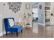 Sitting area featuring wood floors, a decorative wall and a view into the kitchen at 4147 Grandchamp Cir, Palm Harbor, FL 34685