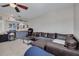 Comfortable living room with a large brown leather sectional sofa and built-in bar for relaxation and entertainment at 4147 Grandchamp Cir, Palm Harbor, FL 34685