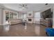 Spacious living room features a stone fireplace, hardwood floors, and a ceiling fan at 4147 Grandchamp Cir, Palm Harbor, FL 34685