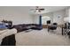 Spacious living room with a large brown leather sectional sofa, ceiling fan, and a dedicated office space at 4147 Grandchamp Cir, Palm Harbor, FL 34685