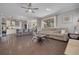 Bright, open-concept living room with hardwood floors connects to the kitchen and patio at 4147 Grandchamp Cir, Palm Harbor, FL 34685
