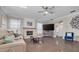 Spacious living room features a stone fireplace, hardwood floors, and a ceiling fan at 4147 Grandchamp Cir, Palm Harbor, FL 34685