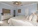 Light-filled bedroom with ceiling fan and pastel blue walls at 4147 Grandchamp Cir, Palm Harbor, FL 34685