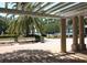 Open pavilion featuring columns, benches, palm trees, and a beautiful waterfront view, perfect for relaxation and enjoying nature at 4147 Grandchamp Cir, Palm Harbor, FL 34685