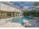 Inviting pool with plenty of space for seating and lush landscaping at 4147 Grandchamp Cir, Palm Harbor, FL 34685
