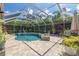 Beautiful screened-in pool with lush landscaping, perfect for outdoor relaxation and entertainment at 4147 Grandchamp Cir, Palm Harbor, FL 34685