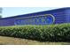 Landscaped community sign with lush green bushes at 4147 Grandchamp Cir, Palm Harbor, FL 34685