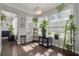 Sunroom with large windows, plenty of natural light, and wood-style flooring with a variety of potted plants at 4147 Grandchamp Cir, Palm Harbor, FL 34685