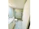 Updated bathroom featuring a glass enclosed shower, marble countertop, and modern fixtures at 4611 W North B St # 228, Tampa, FL 33609