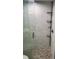 Elegant bathroom shower featuring marble tiles and a pebble floor, offering a spa-like experience at 4611 W North B St # 228, Tampa, FL 33609