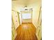 Cozy bedroom with golden wood floors, a ceiling fan, and a window letting in natural light at 4611 W North B St # 228, Tampa, FL 33609