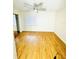 Bright bedroom with hardwood floors, a ceiling fan, and a mirrored closet, offering a cozy retreat at 4611 W North B St # 228, Tampa, FL 33609