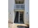 Condominium exterior featuring stucco walls, an entry way, stairwell, and overhead lighting at 4611 W North B St # 228, Tampa, FL 33609