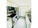 Modern kitchen featuring stainless steel appliances, granite countertops, and white cabinets at 4611 W North B St # 228, Tampa, FL 33609