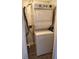 Compact laundry area showcasing a stacked washer and dryer set for convenient in-home laundry at 4611 W North B St # 228, Tampa, FL 33609