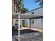 Condominium exterior showcasing covered parking, stucco walls, and green shutters at 4611 W North B St # 228, Tampa, FL 33609