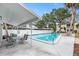 Community pool area with lounge seating and shaded dining spaces, perfect for relaxation and social gatherings at 4611 W North B St # 228, Tampa, FL 33609