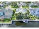 Waterfront home featuring a private dock, boat lift and lush landscaping at 4743 Spinnaker Dr, Bradenton, FL 34208