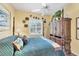 Bright bedroom with a four-poster bed, armoire, and large window featuring plantation shutters at 4743 Spinnaker Dr, Bradenton, FL 34208