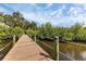 Community wooden boardwalk with rope railings over a canal at 4743 Spinnaker Dr, Bradenton, FL 34208