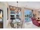 Cozy breakfast nook with pool view, stylish chandelier, and comfortable seating arrangement at 4743 Spinnaker Dr, Bradenton, FL 34208