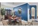 Charming dining room with a bold blue wall, elegant furnishings and ornate mirror and wall decor at 4743 Spinnaker Dr, Bradenton, FL 34208