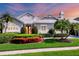 Charming home featuring mature landscaping and a red front door at 4743 Spinnaker Dr, Bradenton, FL 34208